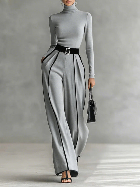Conjunto negro y gris con cuello alto, cinturón y pantalón recto con costuras blancas