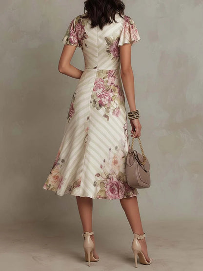 Vestido midi de satén marfil con estampado floral retro, escote cruzado y manga corta