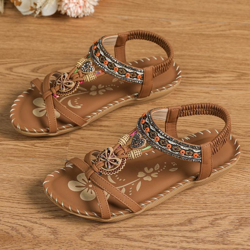 Sandalias ortopédicas Ibiza camel con tiras marrones y adorno floral con pedrería.