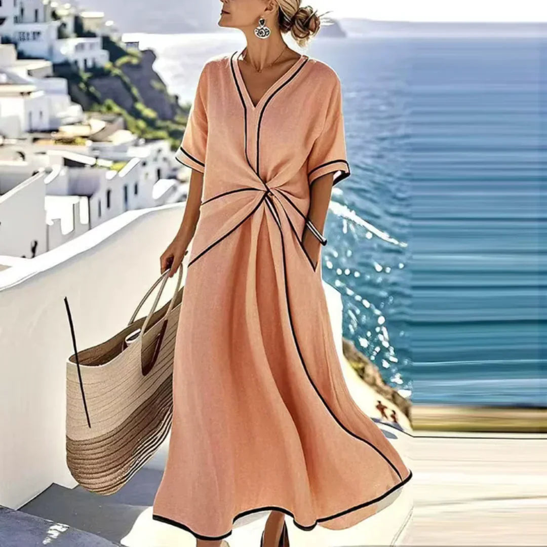 Vestido midi naranja con escote en V y ribete oscuro, lazo fruncido en la cintura