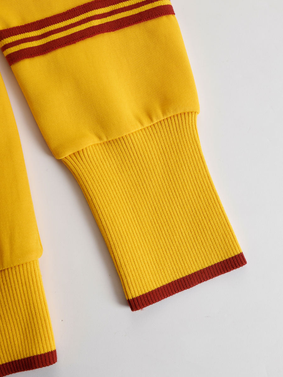 Pantalón de punto acanalado amarillo con ribete granate en el bajo