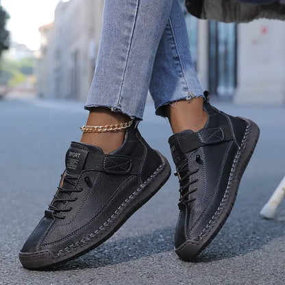 Zapatillas ortopédicas negras con cordones y tira de velcro; suela acolchada con dibujo
