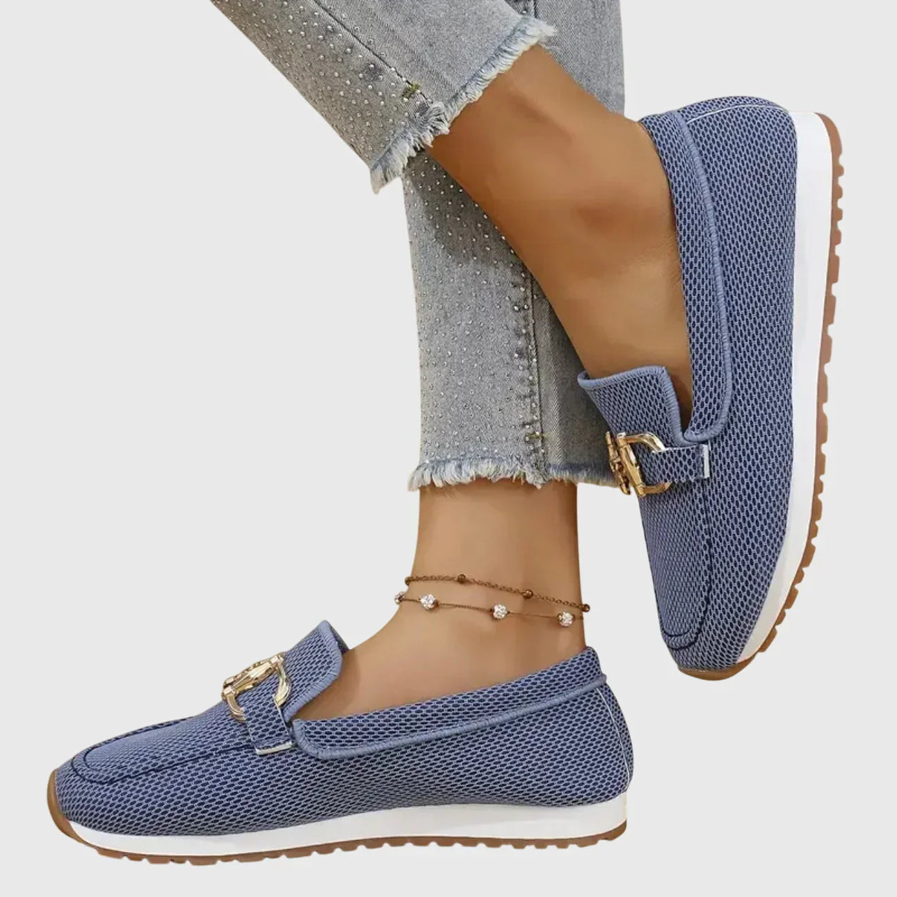 Zapatillas tipo mocasín Chiara azules con hebilla metálica dorada y suela marrón.