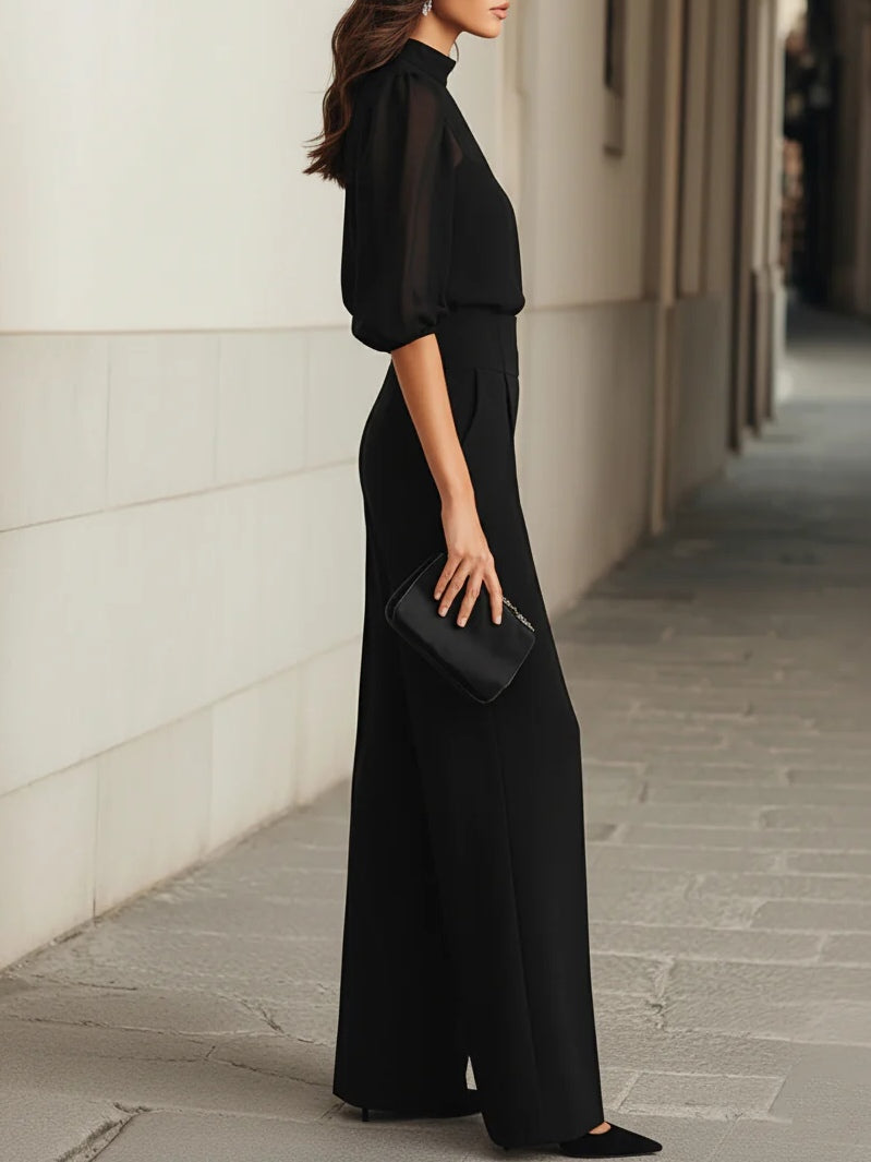 Conjunto negro con blusa de manga globo y pantalón de tiro alto