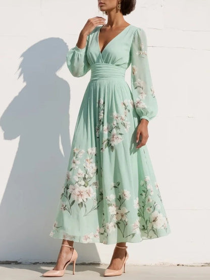 Vestido largo de gasa verde menta con estampado floral, escote pico y mangas globo.