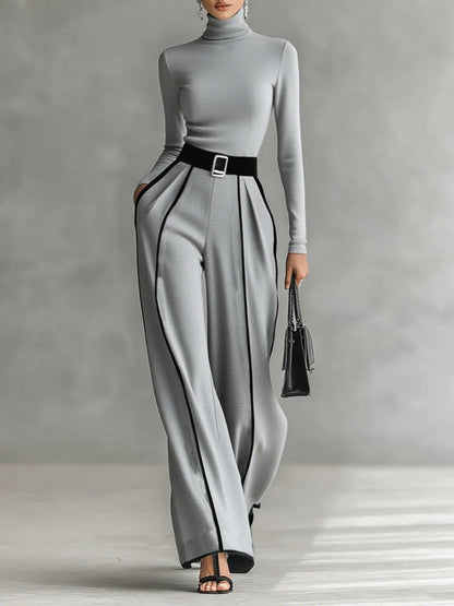 Conjunto negro y gris con cuello alto, cinturón y pantalón recto con costuras blancas