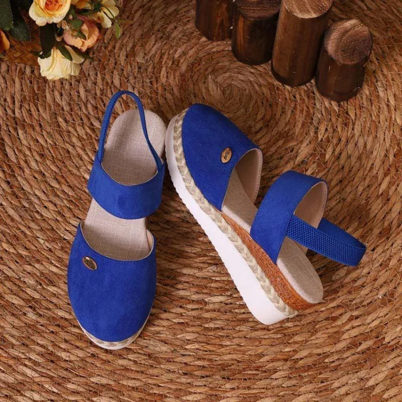 Sandalias azules tipo cuña con tiras cruzadas y suela de yute, con detalle oval