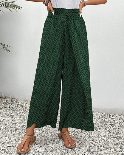 Pantalones de pierna ancha verdes con estampado repetido y caída amplia