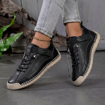 Zapatillas ortopédicas negras con cordones y suela beige con diseño de agarre