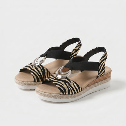 Sandalias ortopédicas con estampado cebra negro y beige y hebilla plateada