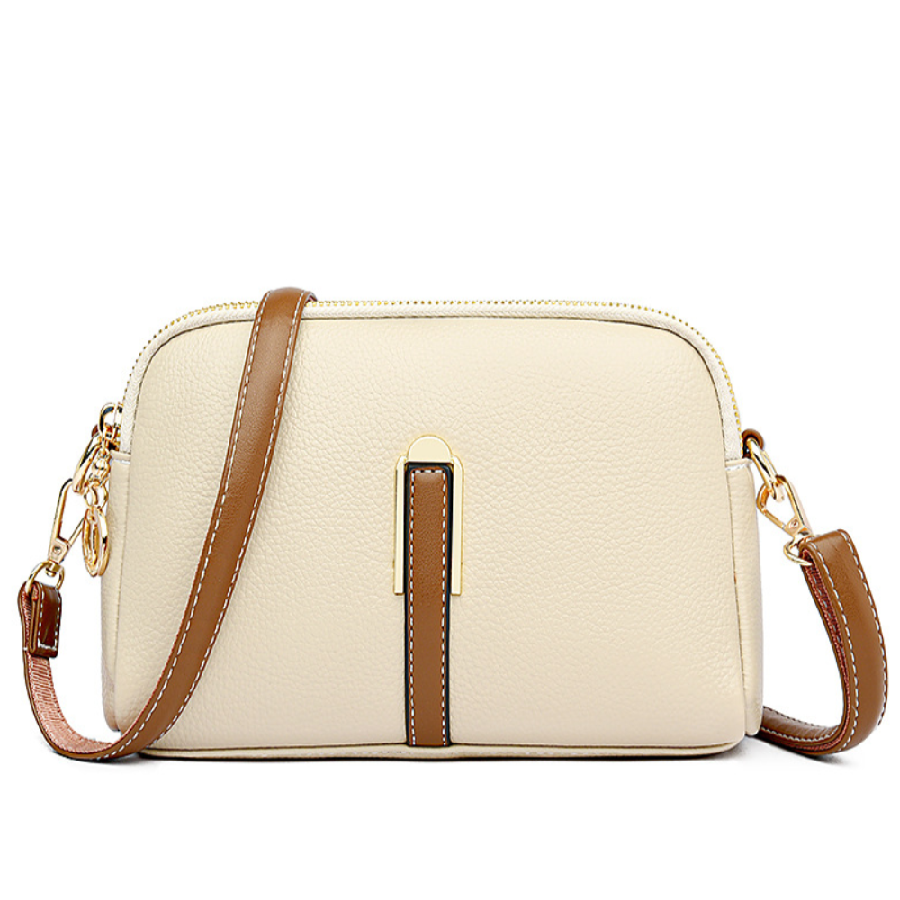 Bolso de hombro crema con textura de lichi, franja marrón central y correa ajustable.