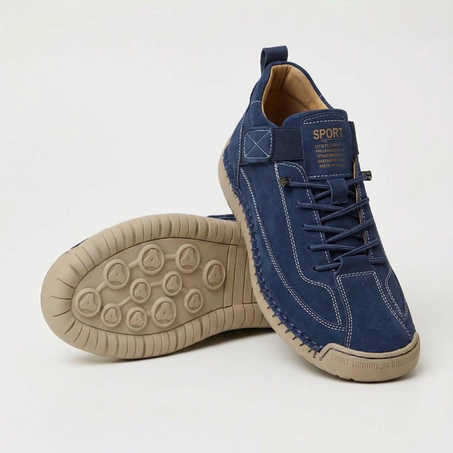 Zapatillas ortopédicas azul marino con cordones, suela beige y panel frontal tipo parche.