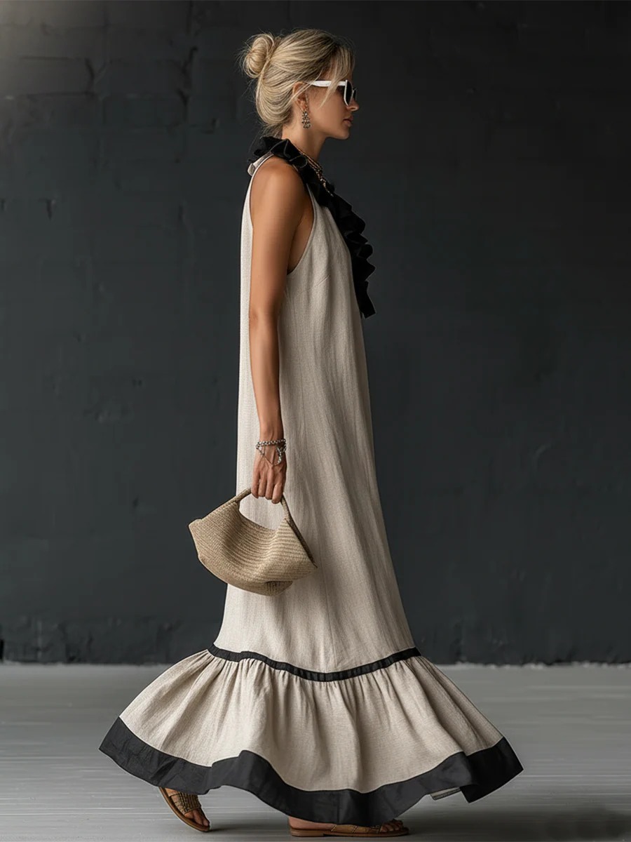Vestido largo sin mangas crema con volantes negros en el escote y falda acampanada