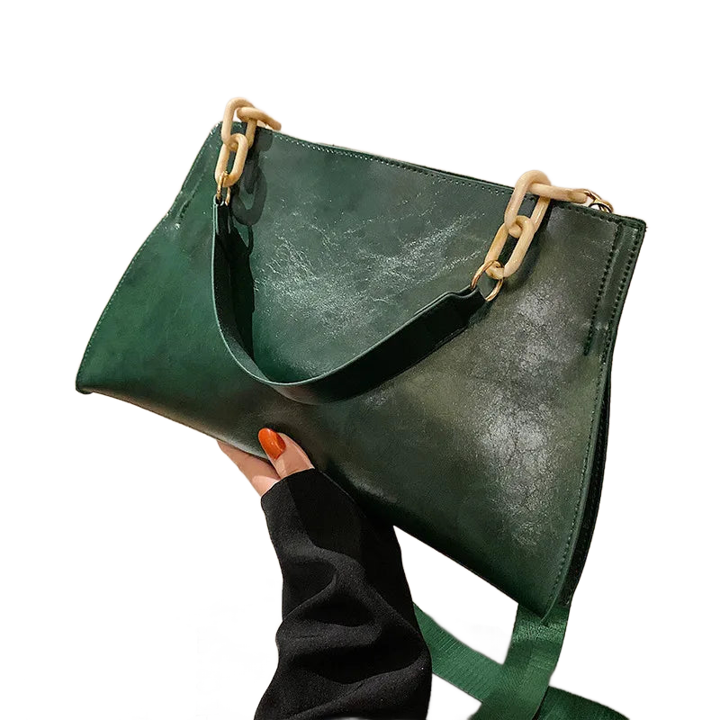 Bolso de hombro de cuero verde con asas metálicas y correa cruzada