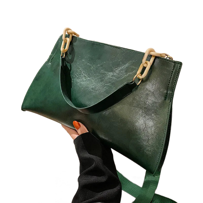 Bolso de hombro de cuero verde con asas metálicas y correa cruzada