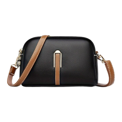 Bolso de hombro negro con textura de lichi y franja marrón central, cierre con cremallera.